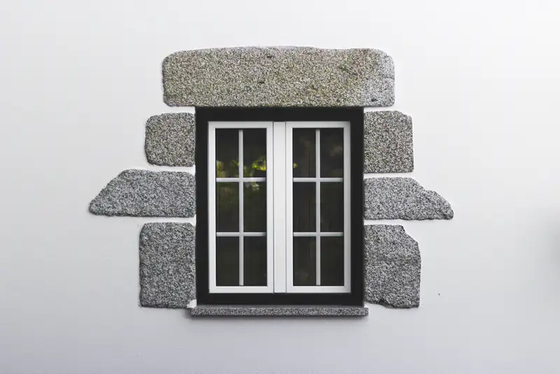 Window & Door Repairs in Newcastle upon Tyne Small white casement window set in a stone surround, illustrating window & door repairs for homes in Newcastle upon Tyne